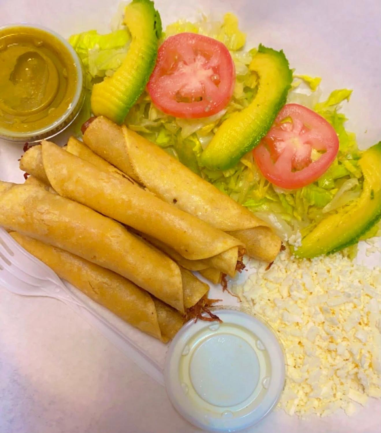 Order of crispy flautas served with salsa, sour cream, lettuce, tomato, queso fresco and avocado
