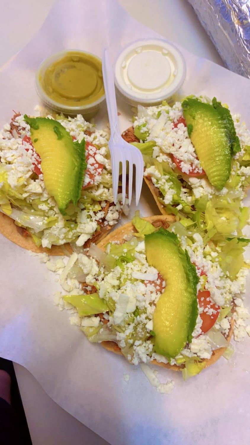 Three chalupas with shredded chicken, lettuce, tomato, queso fresco and avocado plus salsa and cream cups